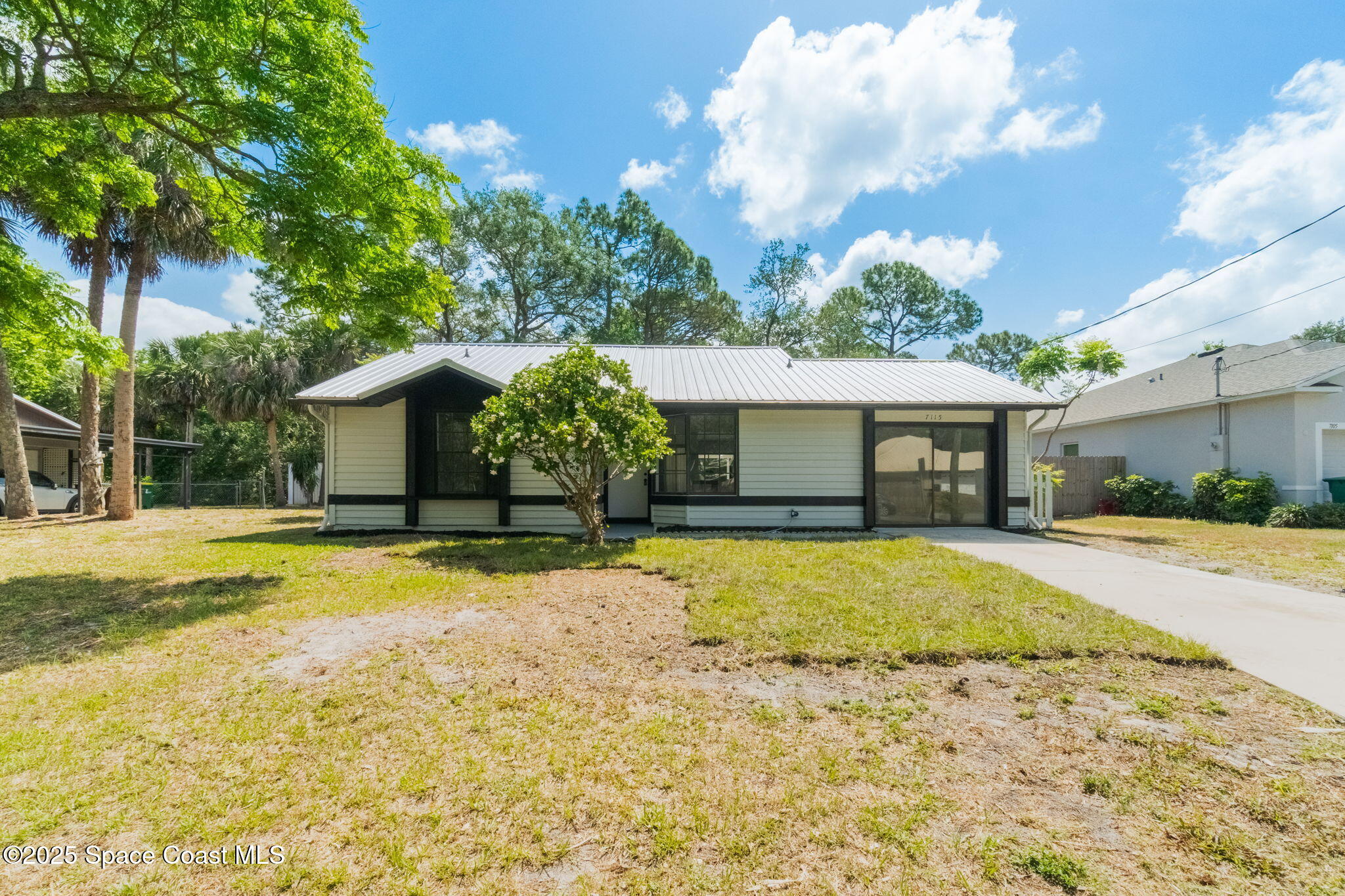 7115 Camilo Road Cocoa, FL 32927 - Photo 3 of 25 a front view of a house with a yard