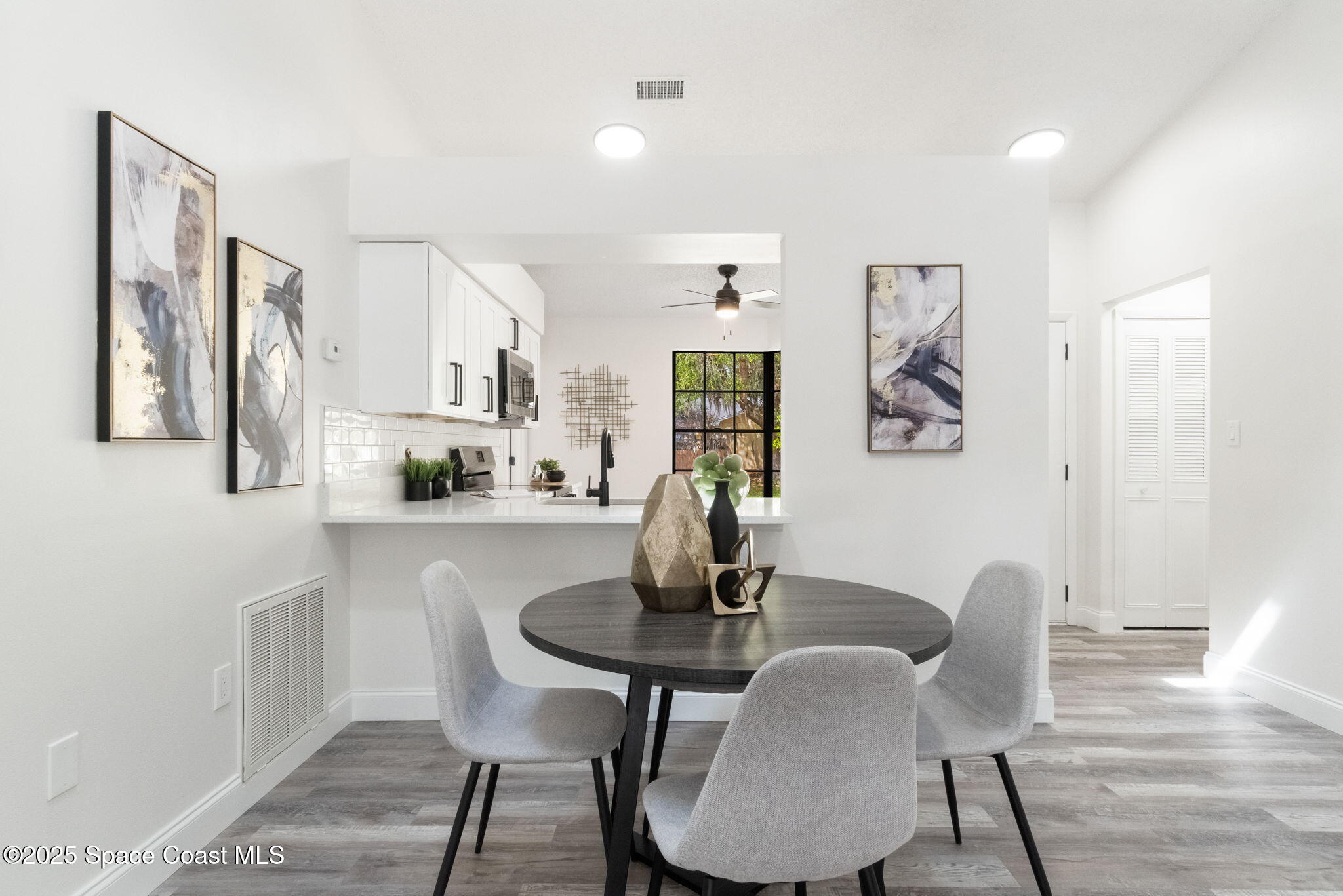 7115 Camilo Road Cocoa, FL 32927 - Photo 5 of 25 a dining room with furniture and wooden floor