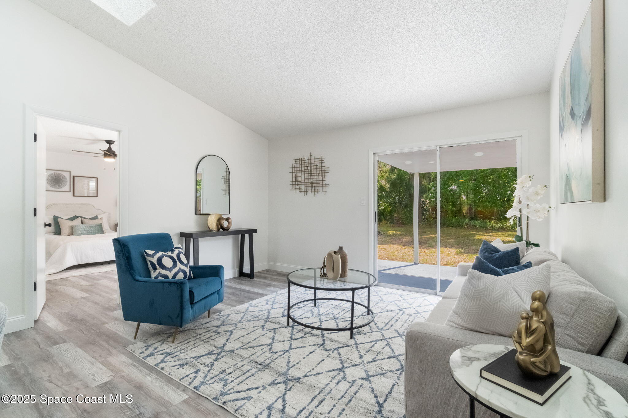 7115 Camilo Road Cocoa, FL 32927 - Photo 6 of 25 a living room with furniture and a floor to ceiling window