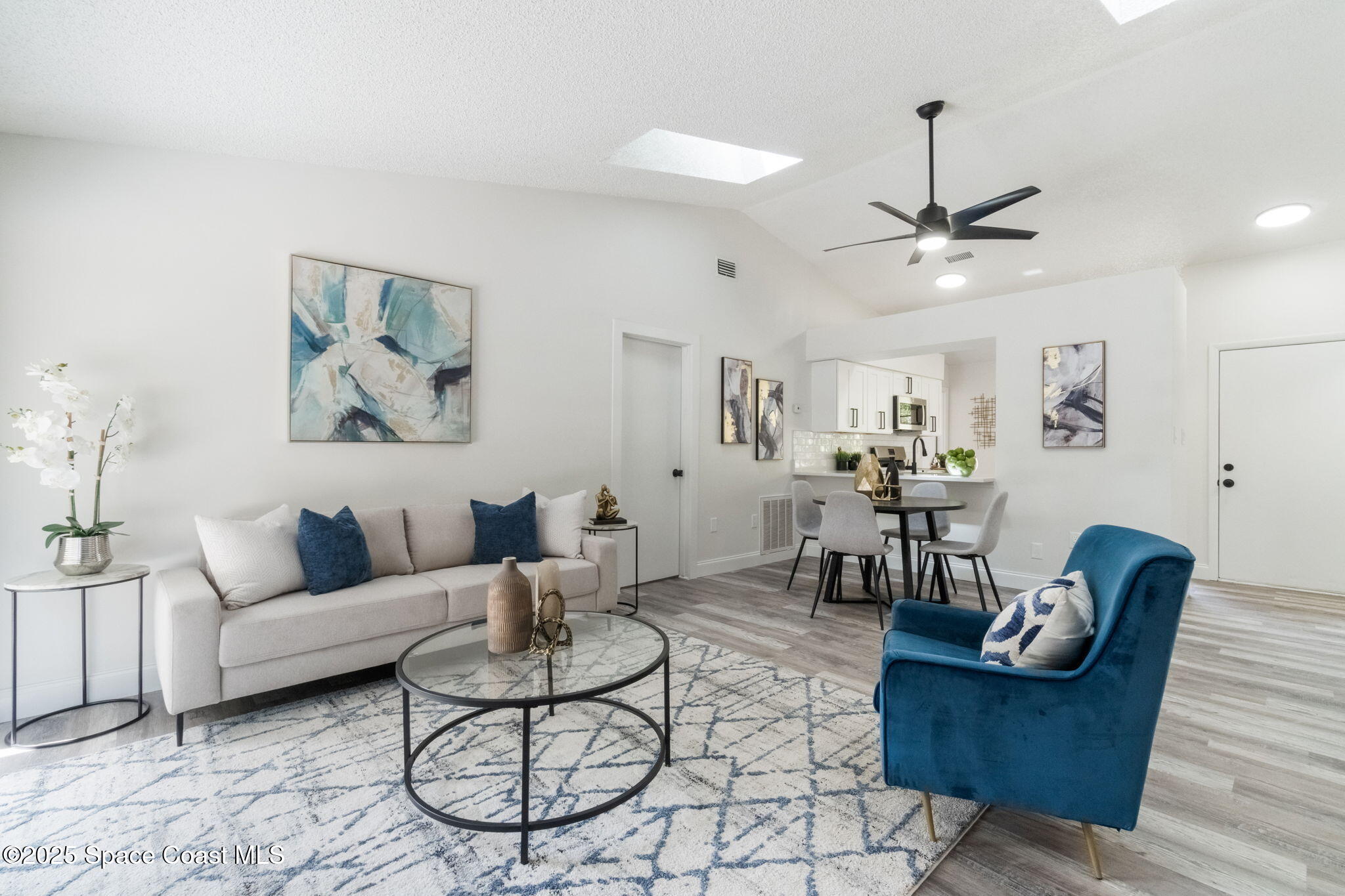7115 Camilo Road Cocoa, FL 32927 - Photo 7 of 25 a living room with furniture and a chandelier