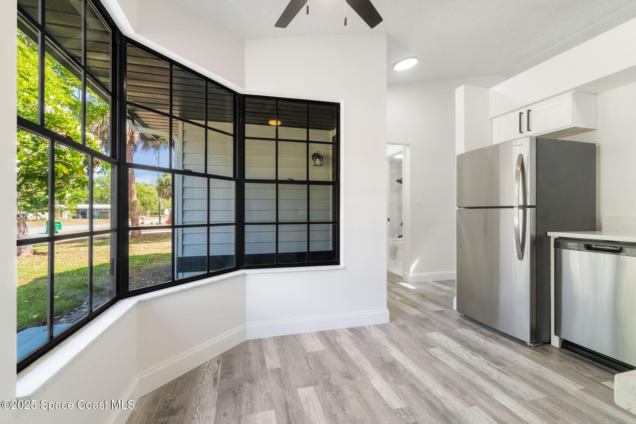 7115 Camilo Road Cocoa, FL 32927 - Photo 9 of 25 a view of a refrigerator in kitchen and an empty room