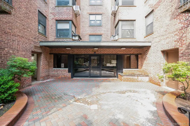 a view of a brick building with many windows