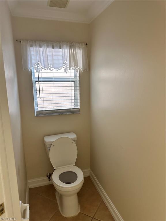 8267 Laurel Lakes Way Naples, FL 34119 - Photo 17 of 23 Bathroom featuring light tile patterned floors and ornamental molding