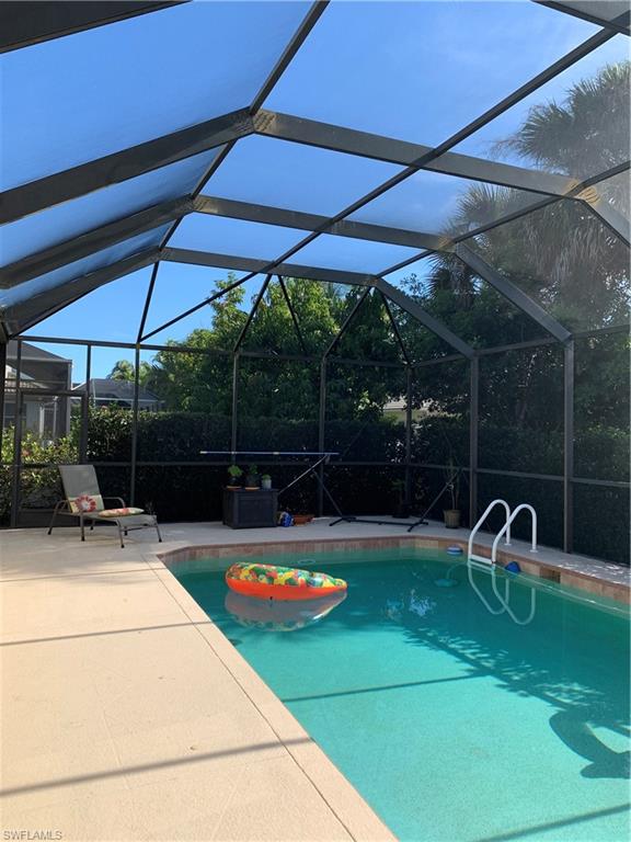 8267 Laurel Lakes Way Naples, FL 34119 - Photo 23 of 23 Swimming pool with a lanai, a sunroom, and a patio
