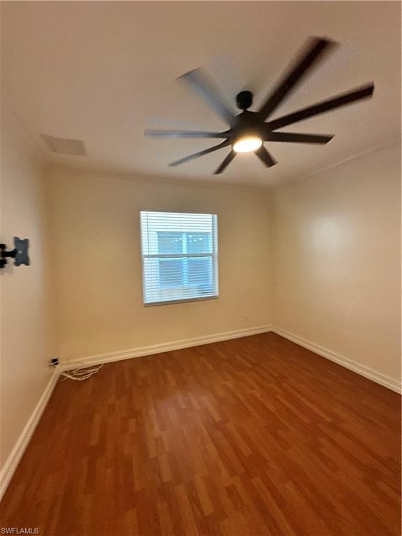 8267 Laurel Lakes Way Naples, FL 34119 - Photo 3 of 23 Spare room with dark wood-type flooring and a ceiling fan
