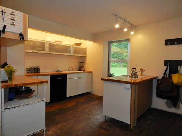 339 Amherst Road Pelham, MA 01002 - Photo 10 of 24 a kitchen with a sink and wooden cabinets