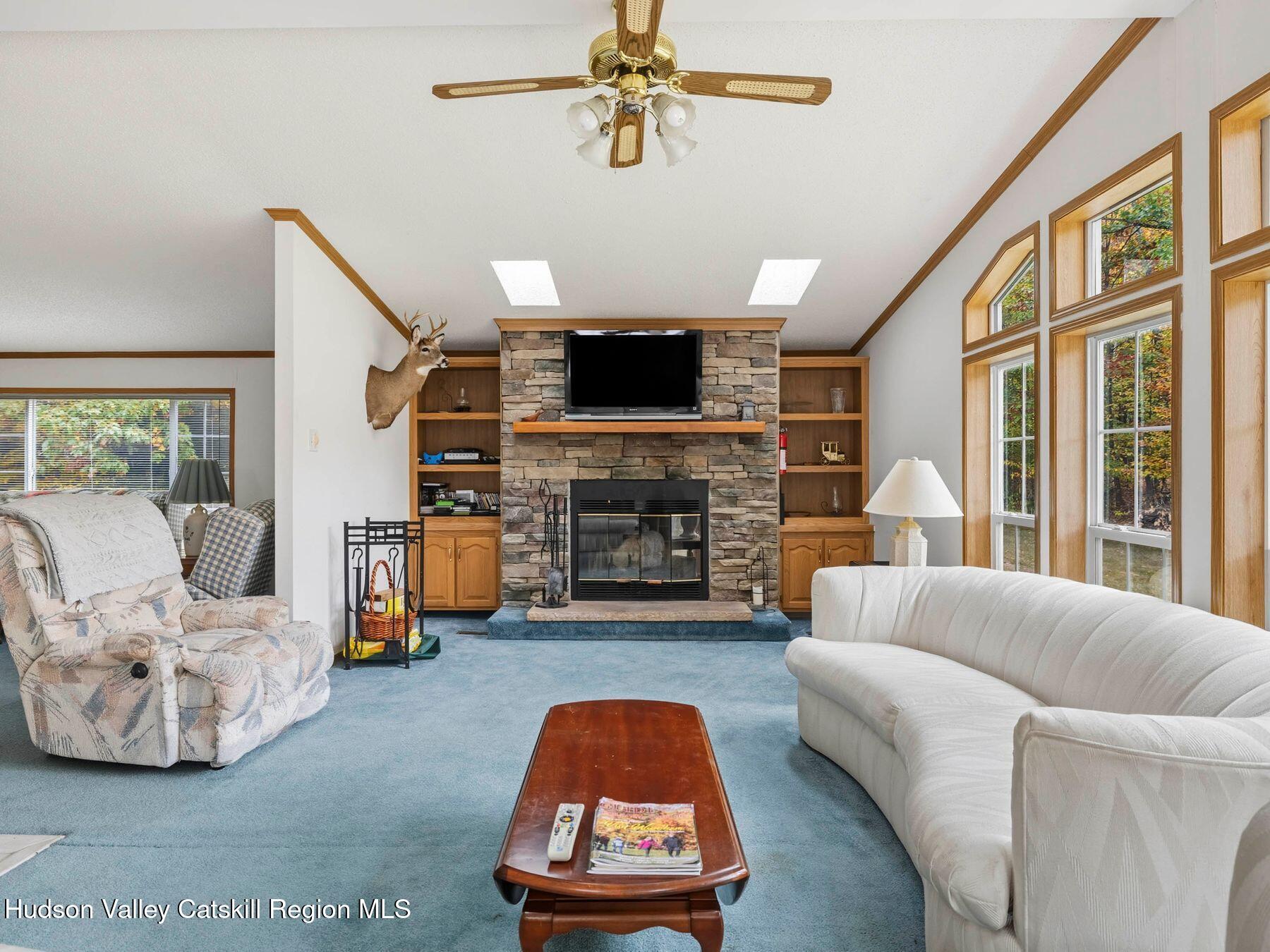 370 Begley Road Windham, NY 12496 - Photo 14 of 51 a living room with furniture a flat screen tv and a fireplace
