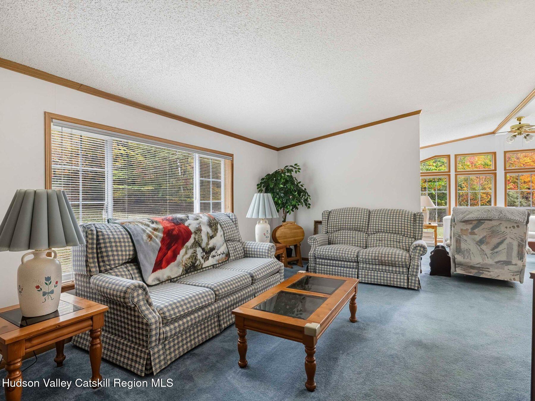 370 Begley Road Windham, NY 12496 - Photo 17 of 51 a living room with furniture and a large window