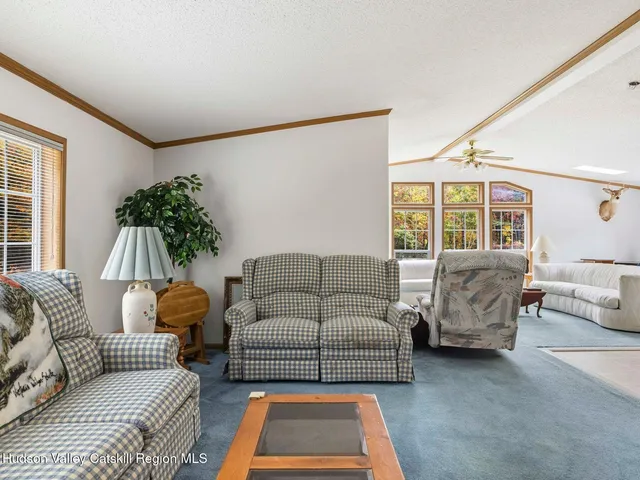 a living room with furniture a dining table and kitchen view