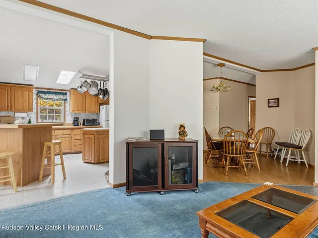 a kitchen with stainless steel appliances granite countertop a stove top oven a sink dishwasher and white cabinets with wooden floor