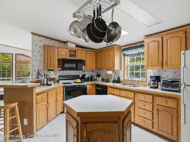 a kitchen with a sink a stove and cabinets