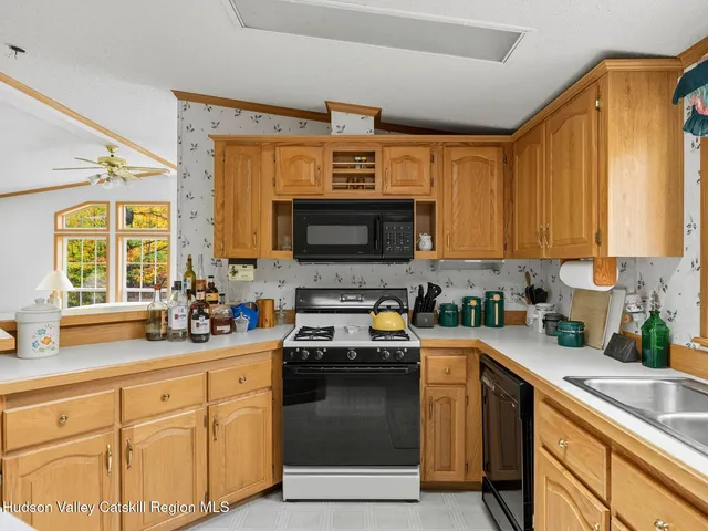 a kitchen with stainless steel appliances a sink stove and cabinets