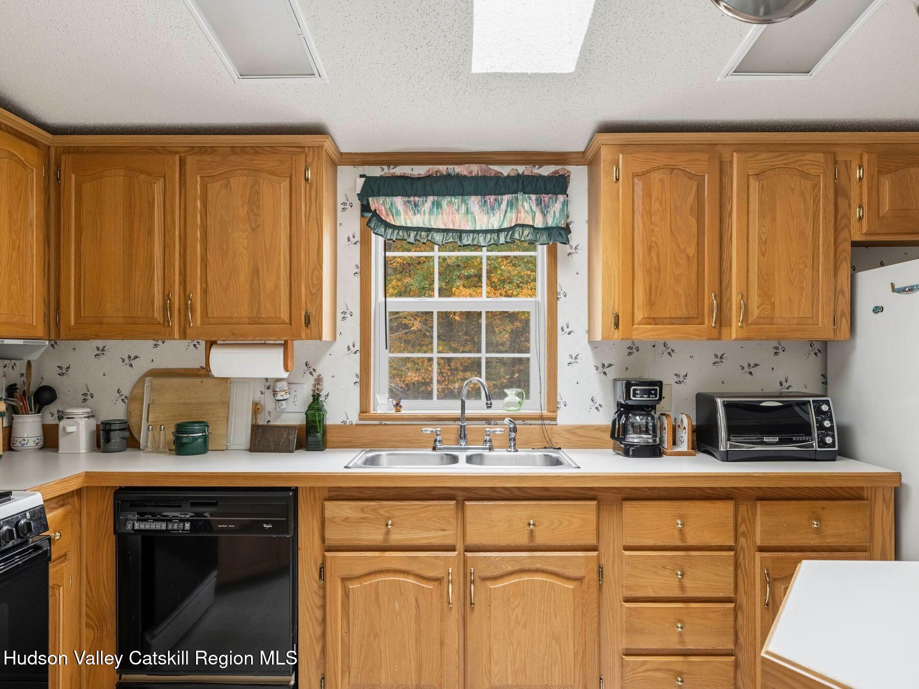 370 Begley Road Windham, NY 12496 - Photo 22 of 51 a kitchen with stainless steel appliances a sink stove and cabinets
