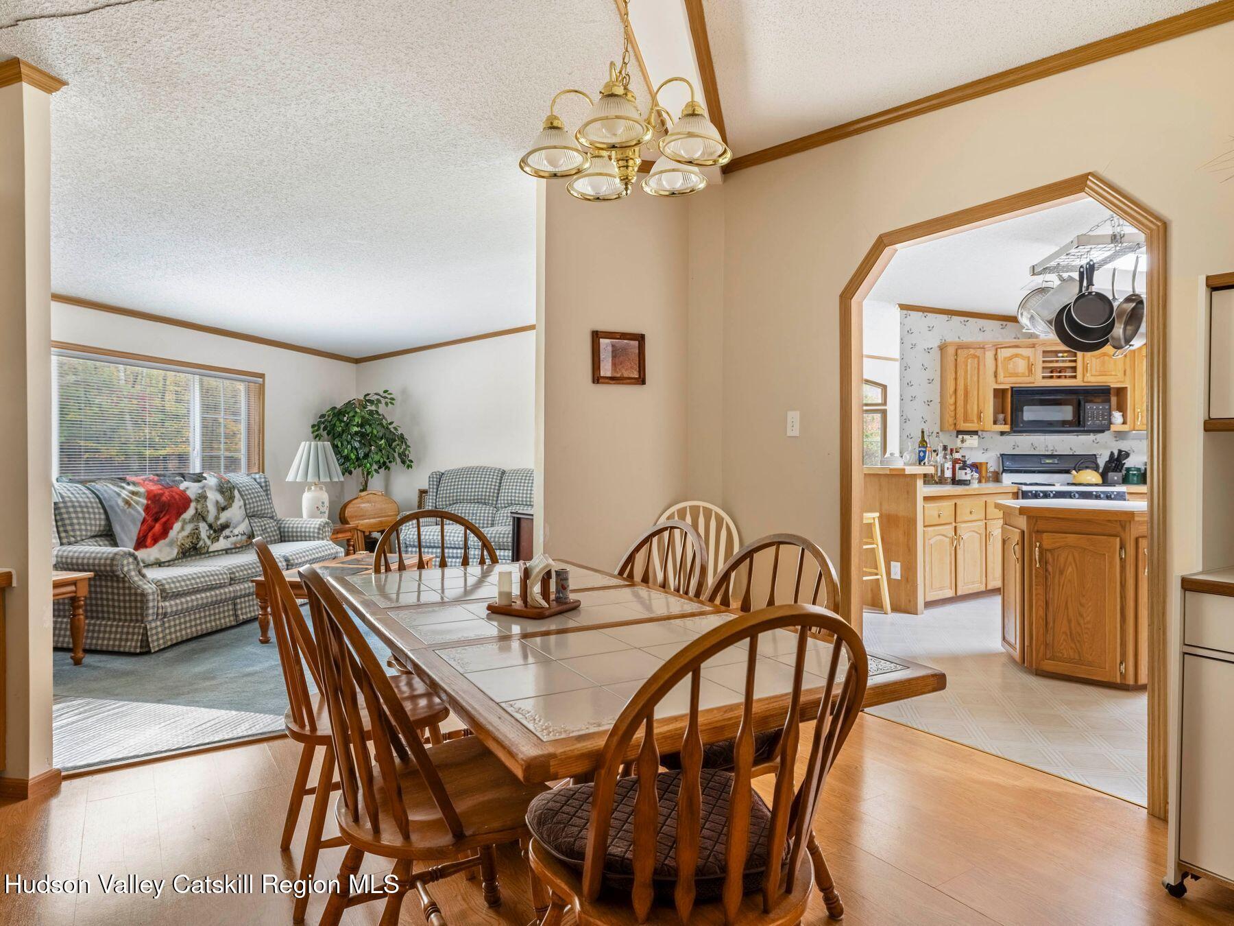 370 Begley Road Windham, NY 12496 - Photo 24 of 51 a dining room with furniture a chandelier and wooden floor
