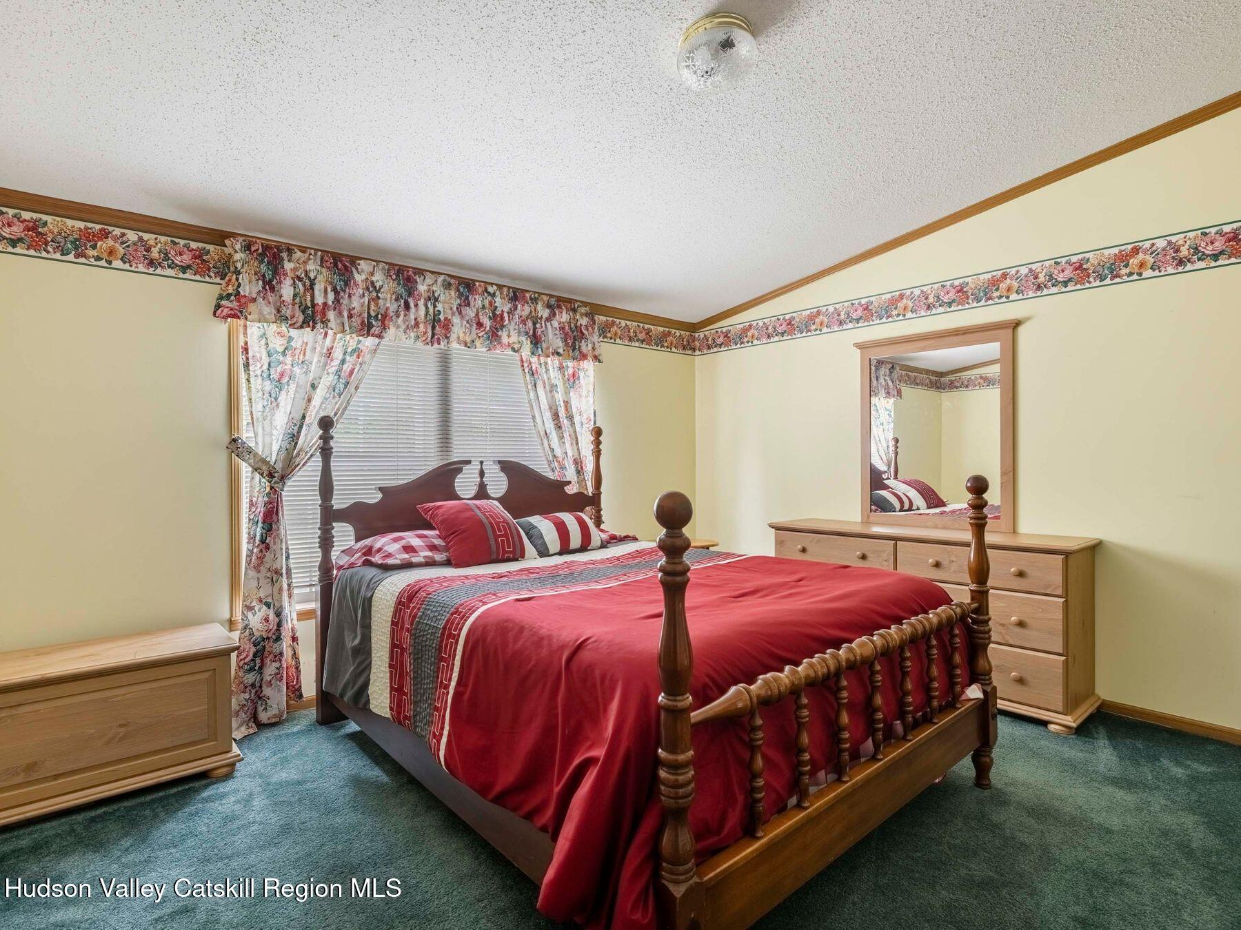 370 Begley Road Windham, NY 12496 - Photo 26 of 51 a bed sitting in a bedroom next to a window