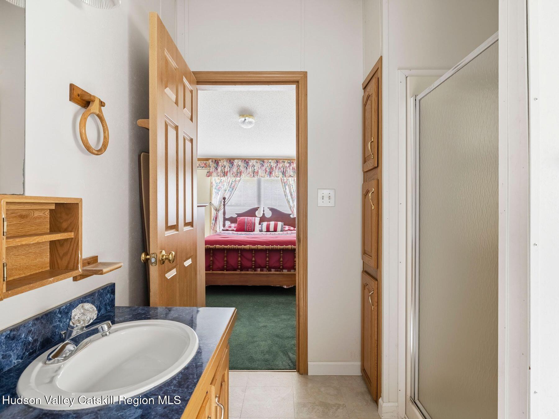 370 Begley Road Windham, NY 12496 - Photo 29 of 51 a bathroom with a tub sink and mirror