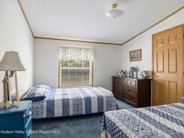 a bedroom with a bed and a lamp on table