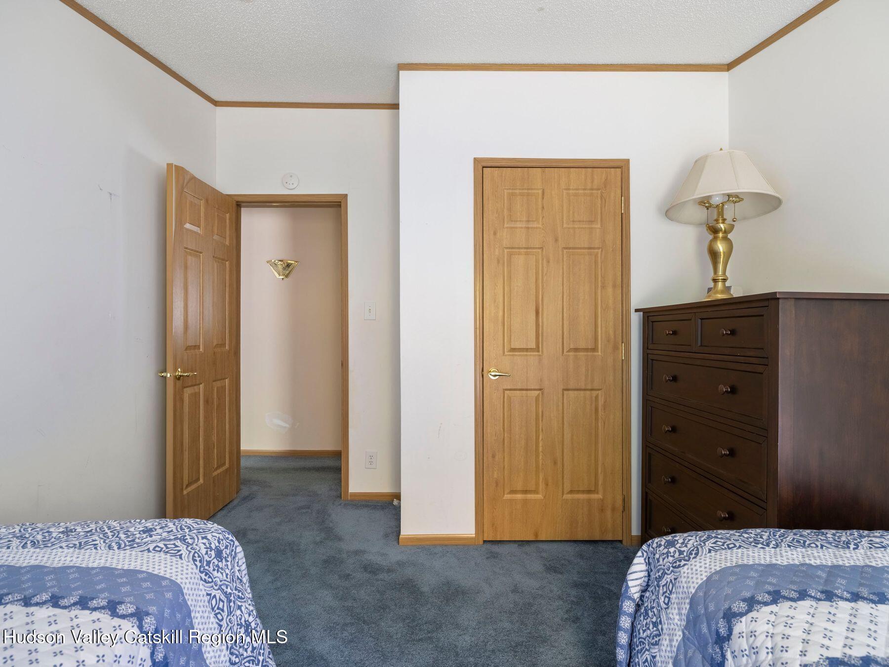 370 Begley Road Windham, NY 12496 - Photo 33 of 51 a bedroom with a bed and a dresser