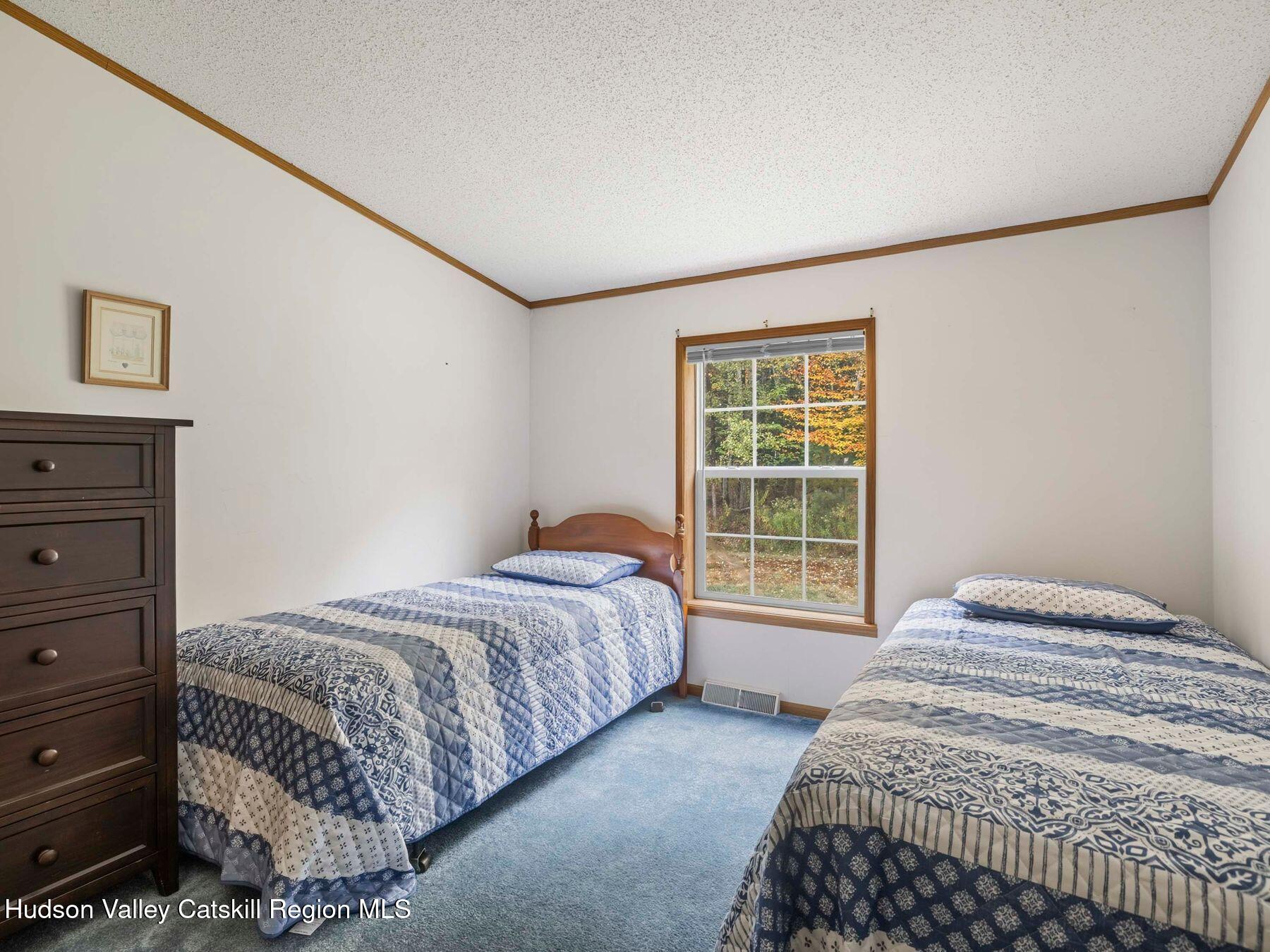 370 Begley Road Windham, NY 12496 - Photo 34 of 51 a bedroom with a bed and a window