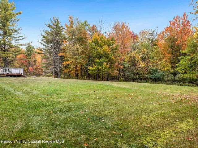 a view of yard with swimming pool and trees