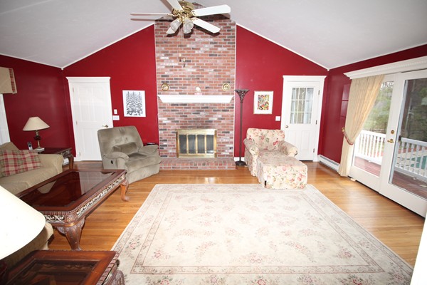 4 Lyn Path Hopkinton, MA 01748 - Photo 12 of 28 a spacious bedroom with a large bed and a chandelier