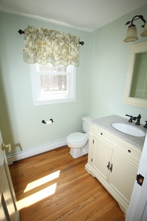 4 Lyn Path Hopkinton, MA 01748 - Photo 15 of 28 a bathroom with a sink and a mirror