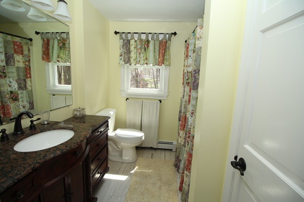 4 Lyn Path Hopkinton, MA 01748 - Photo 17 of 28 a bathroom with a granite countertop sink toilet and shower