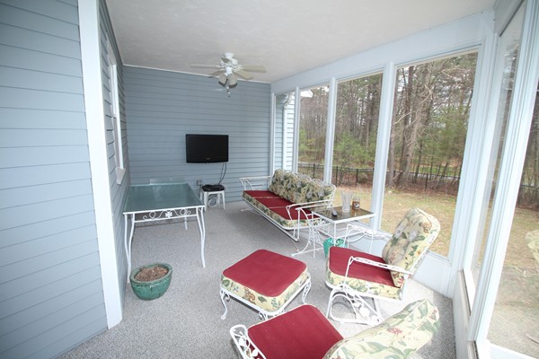 4 Lyn Path Hopkinton, MA 01748 - Photo 23 of 28 a living room with furniture and a flat screen tv