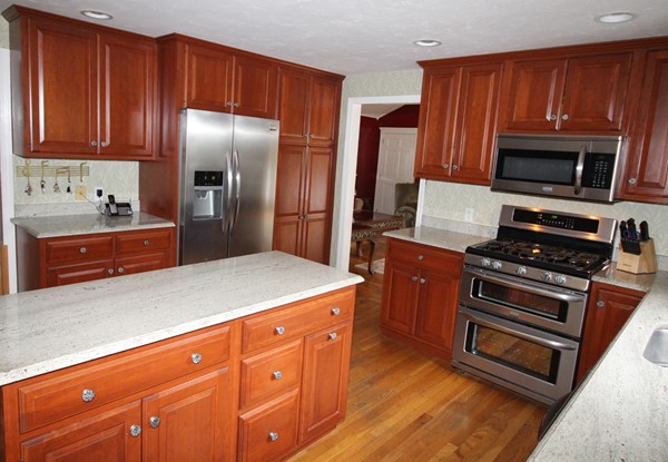 4 Lyn Path Hopkinton, MA 01748 - Photo 7 of 28 a kitchen with wooden cabinets a stove and a refrigerator
