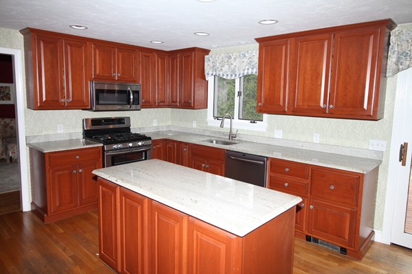 4 Lyn Path Hopkinton, MA 01748 - Photo 8 of 28 a kitchen with stainless steel appliances granite countertop wooden cabinets a stove a sink and dishwasher with wooden floor