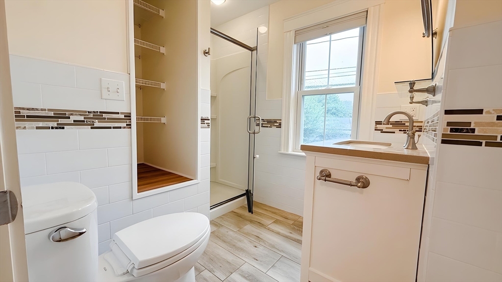 114 Curve Street Dedham, MA 02026 - Photo 12 of 27 a bathroom with a sink toilet and shower