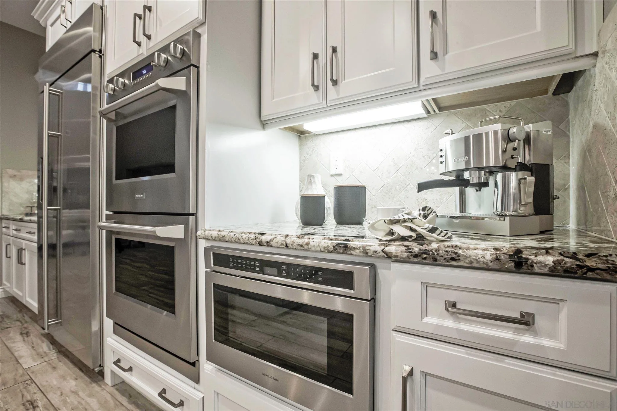 545 Ledge Street San Marcos, CA 92078 - Photo 17 of 55 a kitchen with stainless steel appliances granite countertop a stove and a microwave