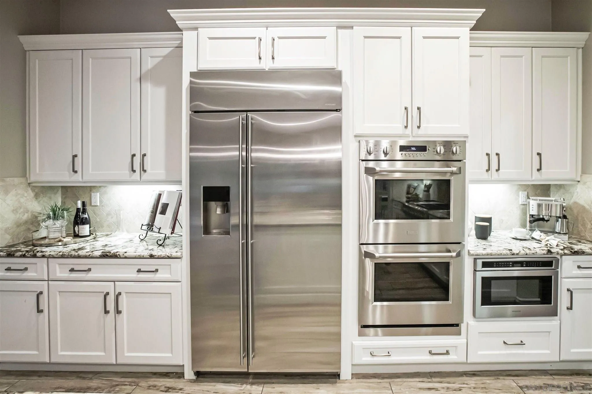 545 Ledge Street San Marcos, CA 92078 - Photo 18 of 55 a kitchen with white cabinets and stainless steel appliances