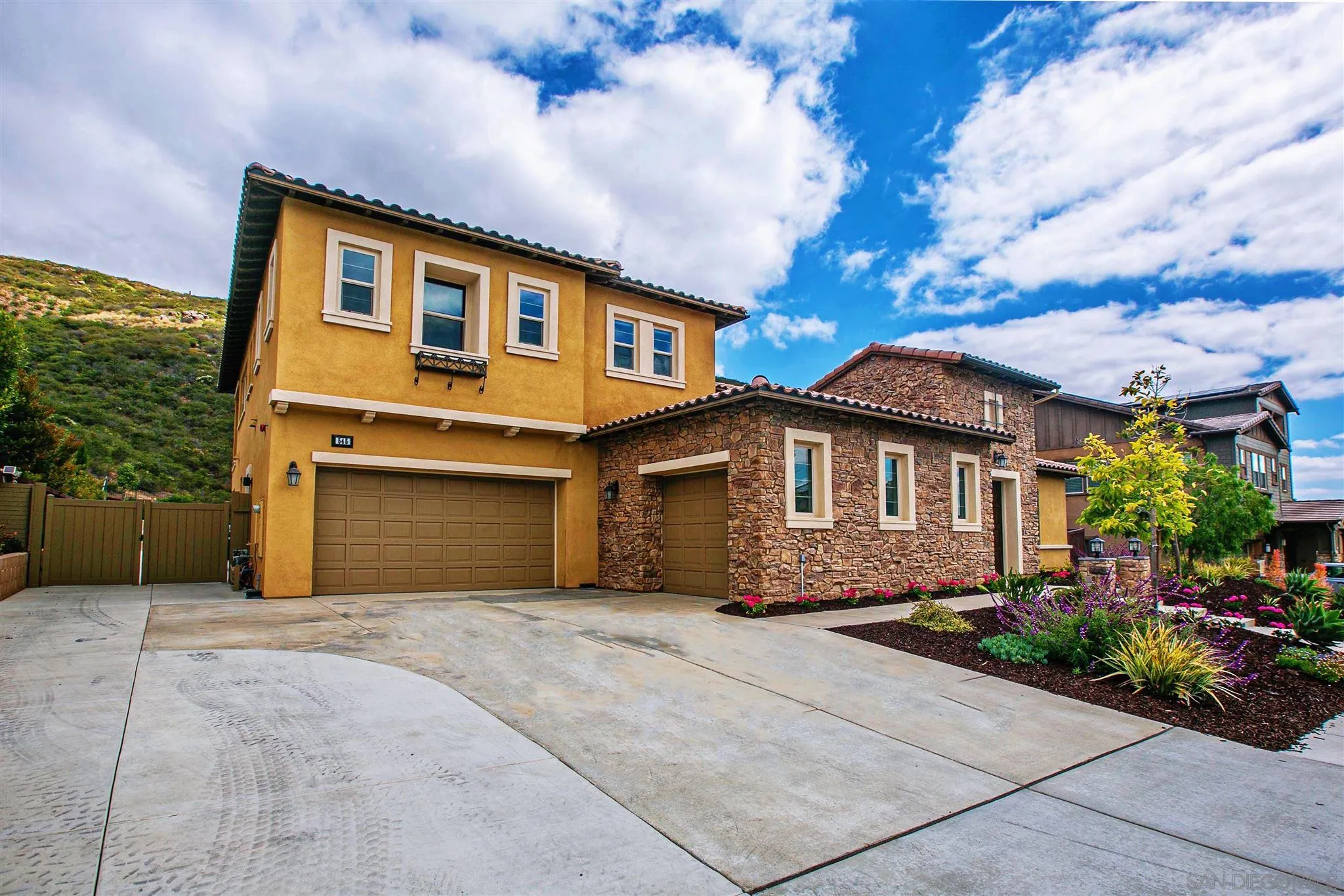 545 Ledge Street San Marcos, CA 92078 - Photo 3 of 55 a front view of a house with a garden