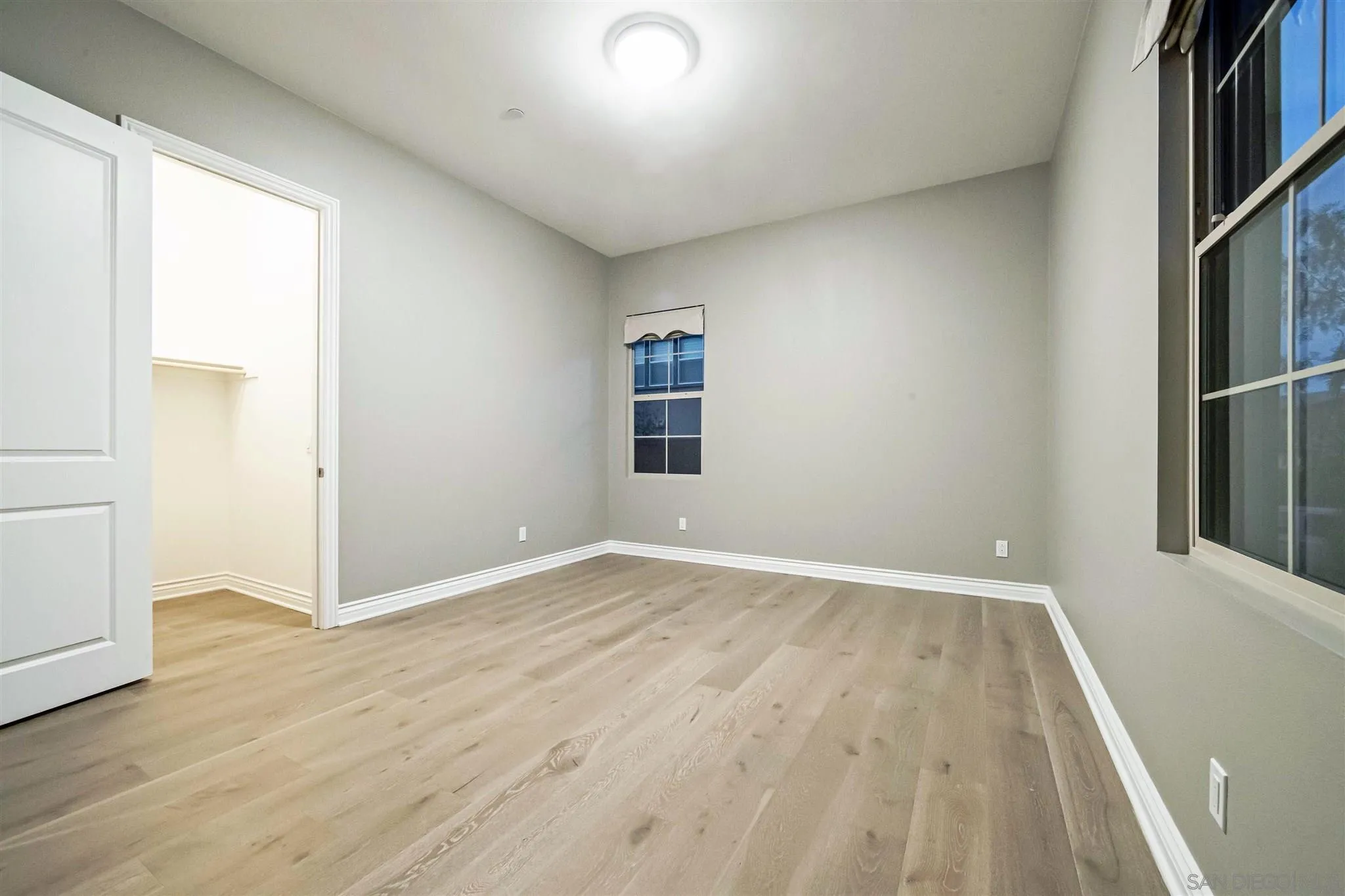 545 Ledge Street San Marcos, CA 92078 - Photo 36 of 55 an empty room with wooden floor and windows