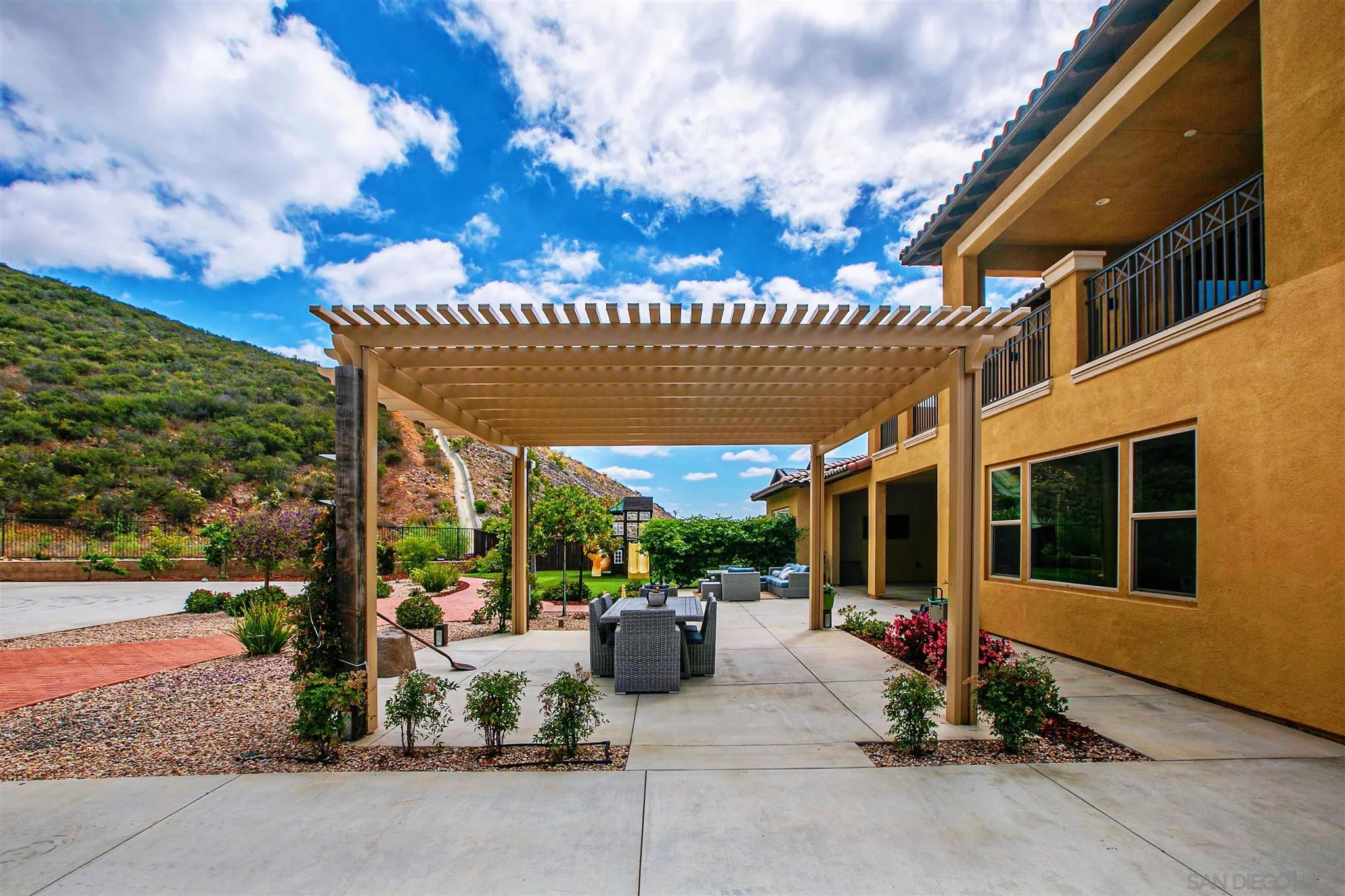 545 Ledge Street San Marcos, CA 92078 - Photo 47 of 55 a view of a patio with a table and chairs under an umbrella