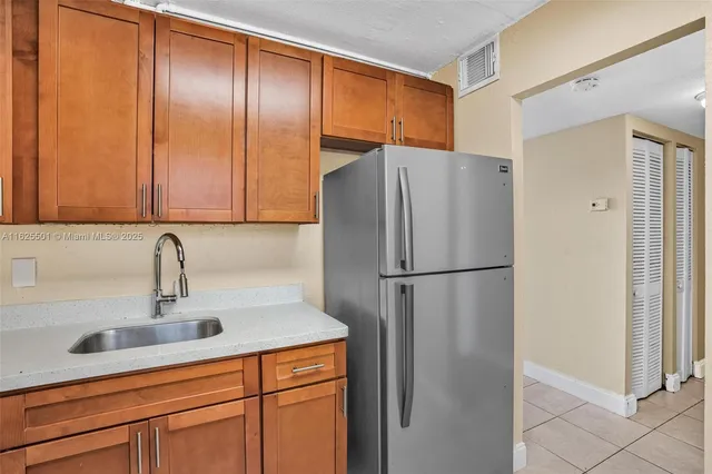 a white refrigerator freezer sitting in a kitchen