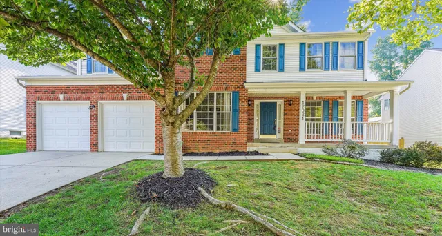 a front view of a house with garden and porch