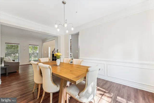 a kitchen with granite countertop a refrigerator a sink a stove and cabinets