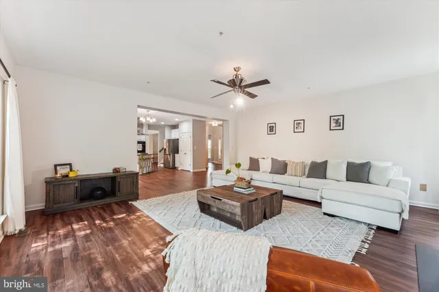 a spacious bedroom with a large bed and a chandelier