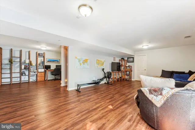 a front view of a house with swimming pool and sitting area