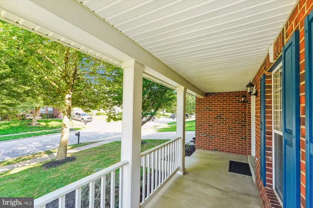 a view of a livingroom with wooden floor and staircase