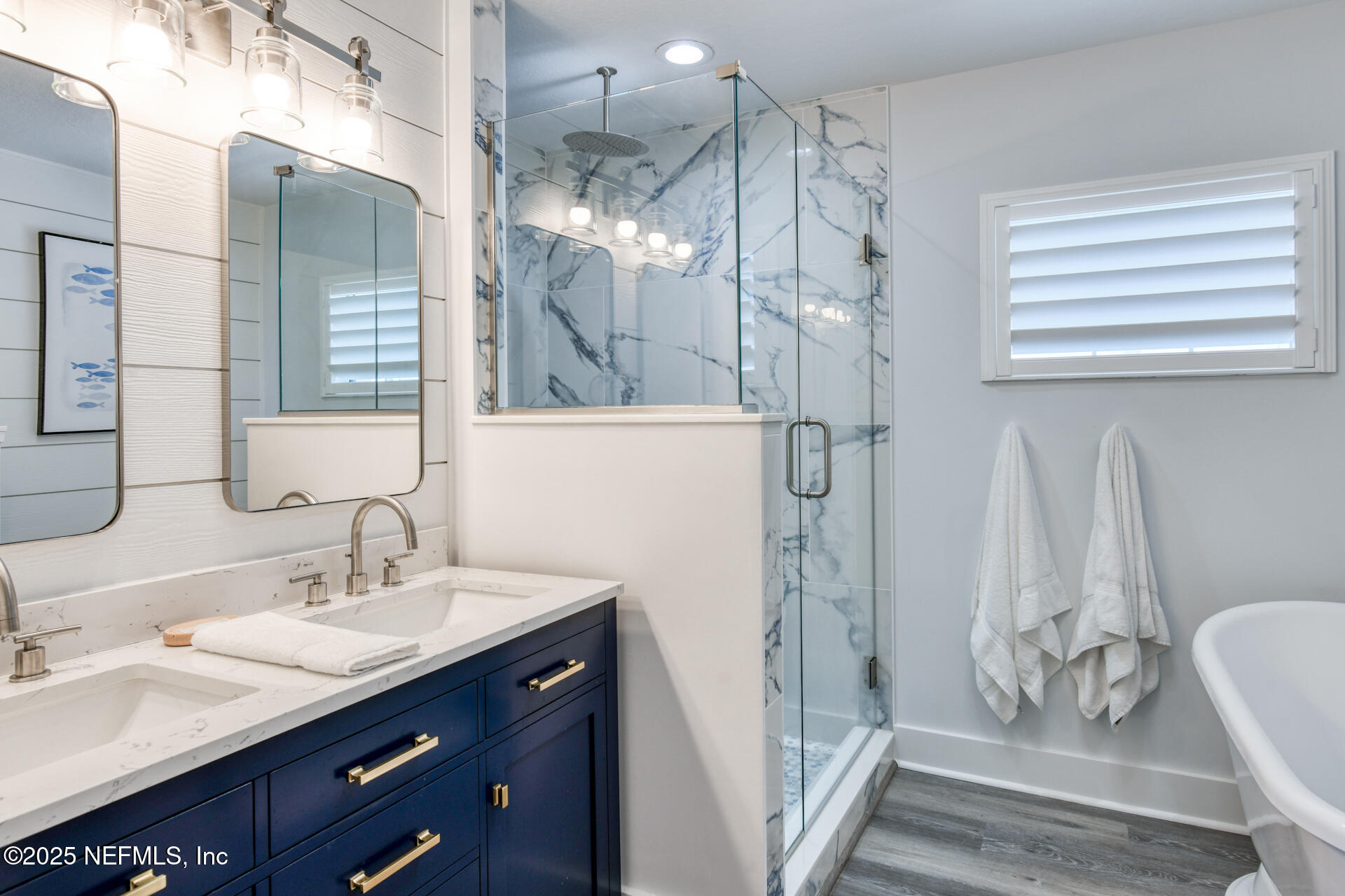 5072 Atlantic View St. Augustine, FL 32080 - Photo 26 of 68 a bathroom with a double vanity sink mirror and shower