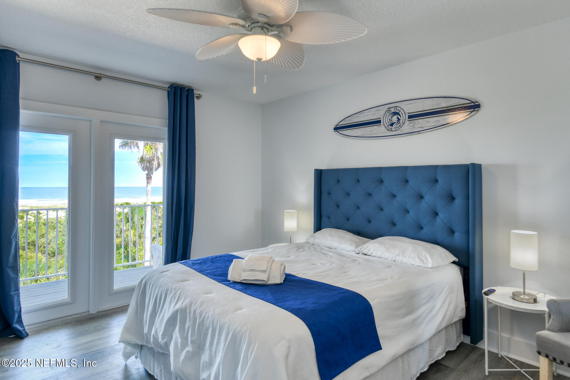 5072 Atlantic View St. Augustine, FL 32080 - Photo 29 of 68 a bedroom with a large bed and a chandelier