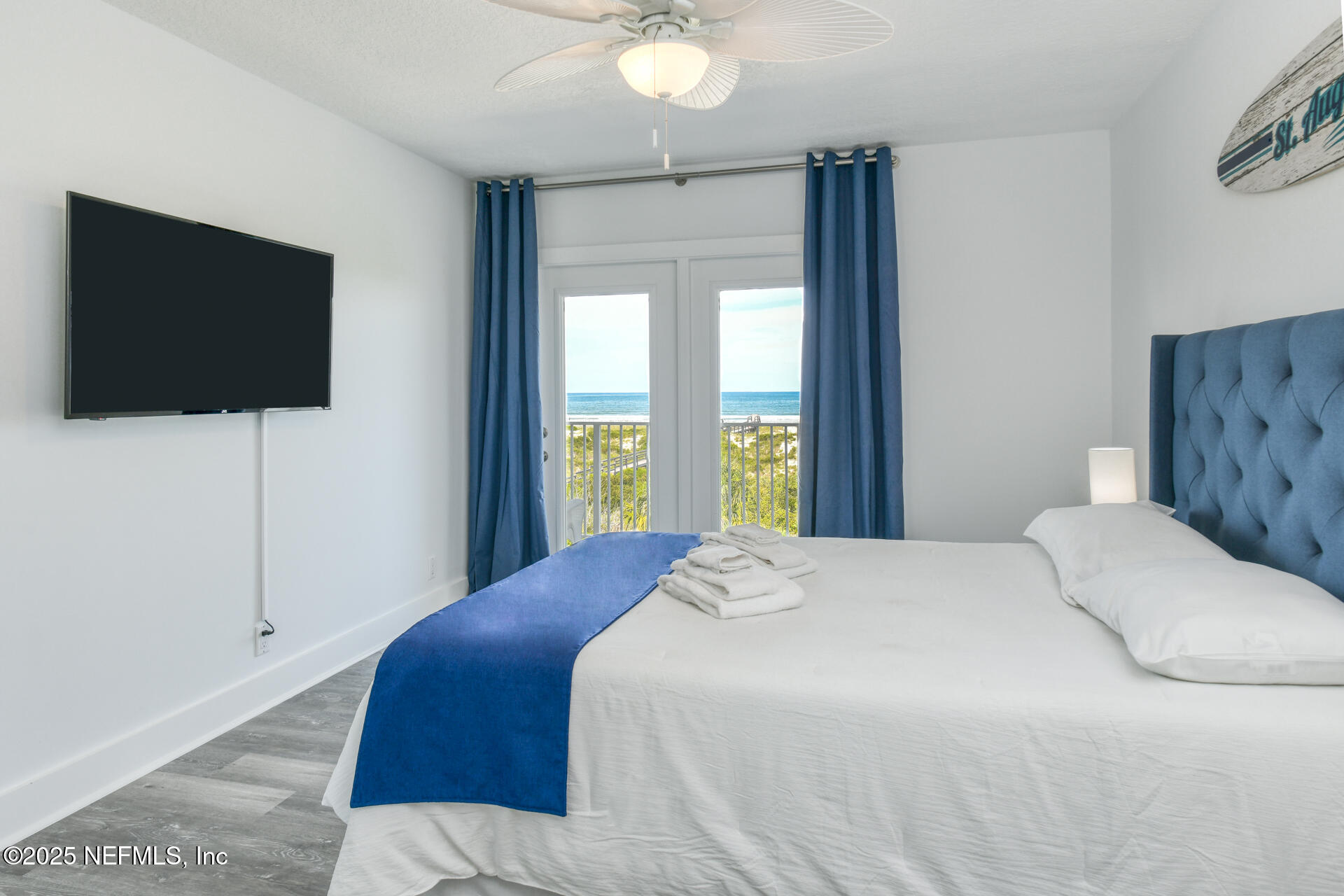 5072 Atlantic View St. Augustine, FL 32080 - Photo 34 of 68 a bedroom with a flat screen tv and a bed