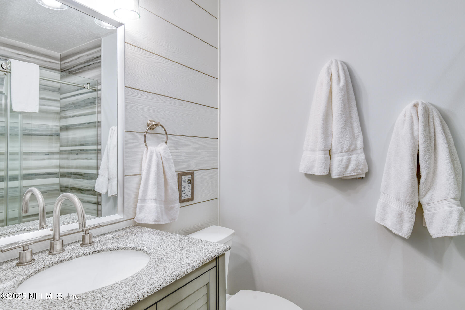 5072 Atlantic View St. Augustine, FL 32080 - Photo 36 of 68 a bathroom with a granite countertop sink and a mirror