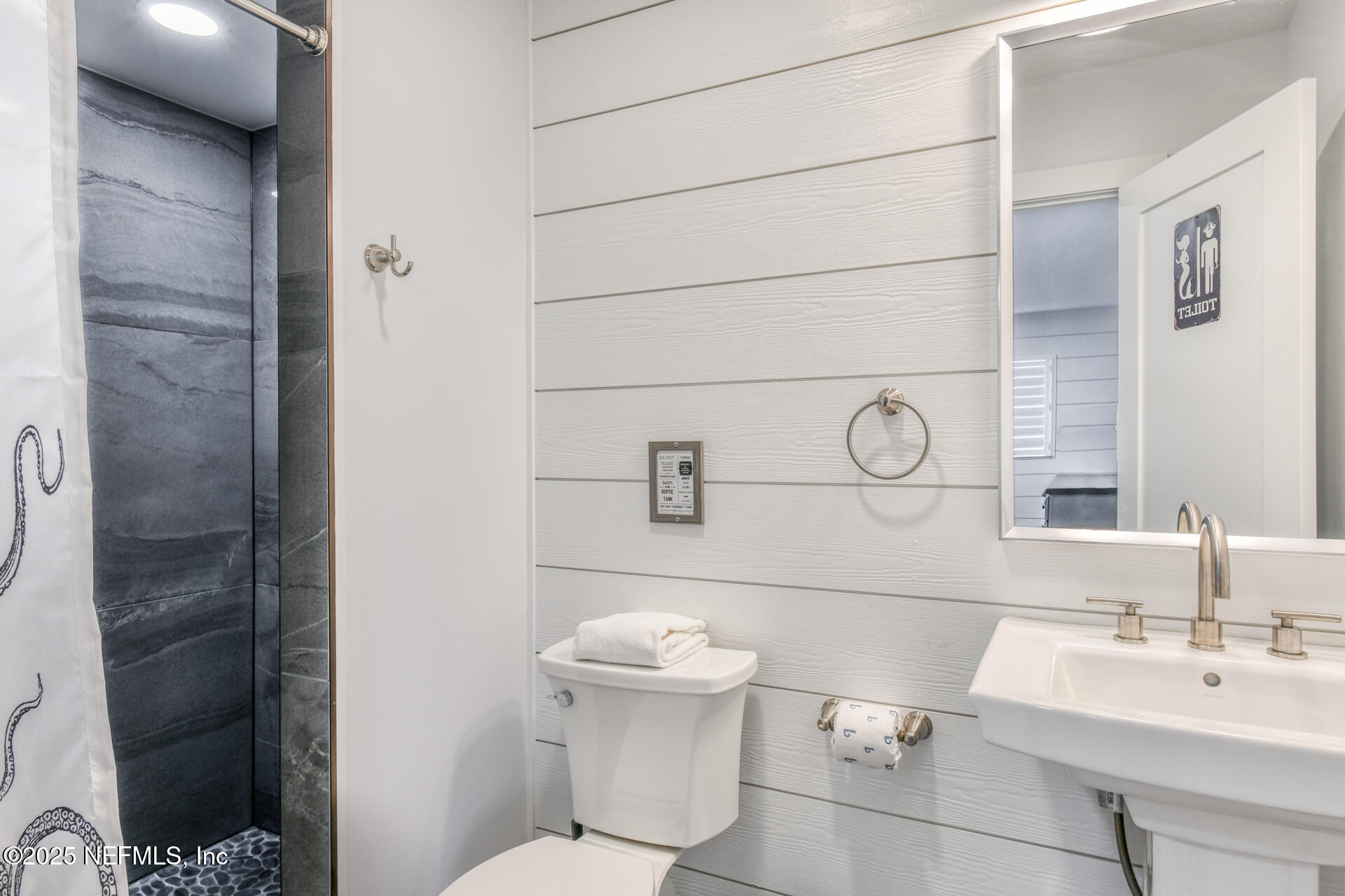 5072 Atlantic View St. Augustine, FL 32080 - Photo 46 of 68 a bathroom with a sink a toilet and mirror