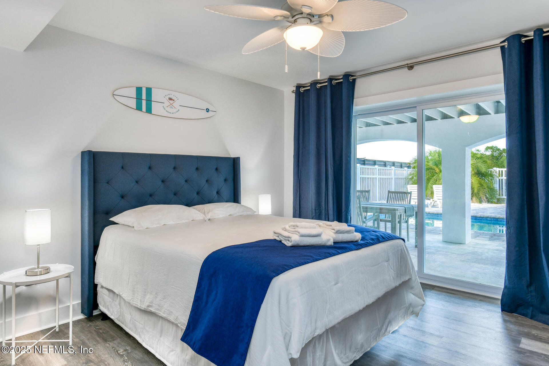 5072 Atlantic View St. Augustine, FL 32080 - Photo 47 of 68 a bedroom with a large bed and a chandelier