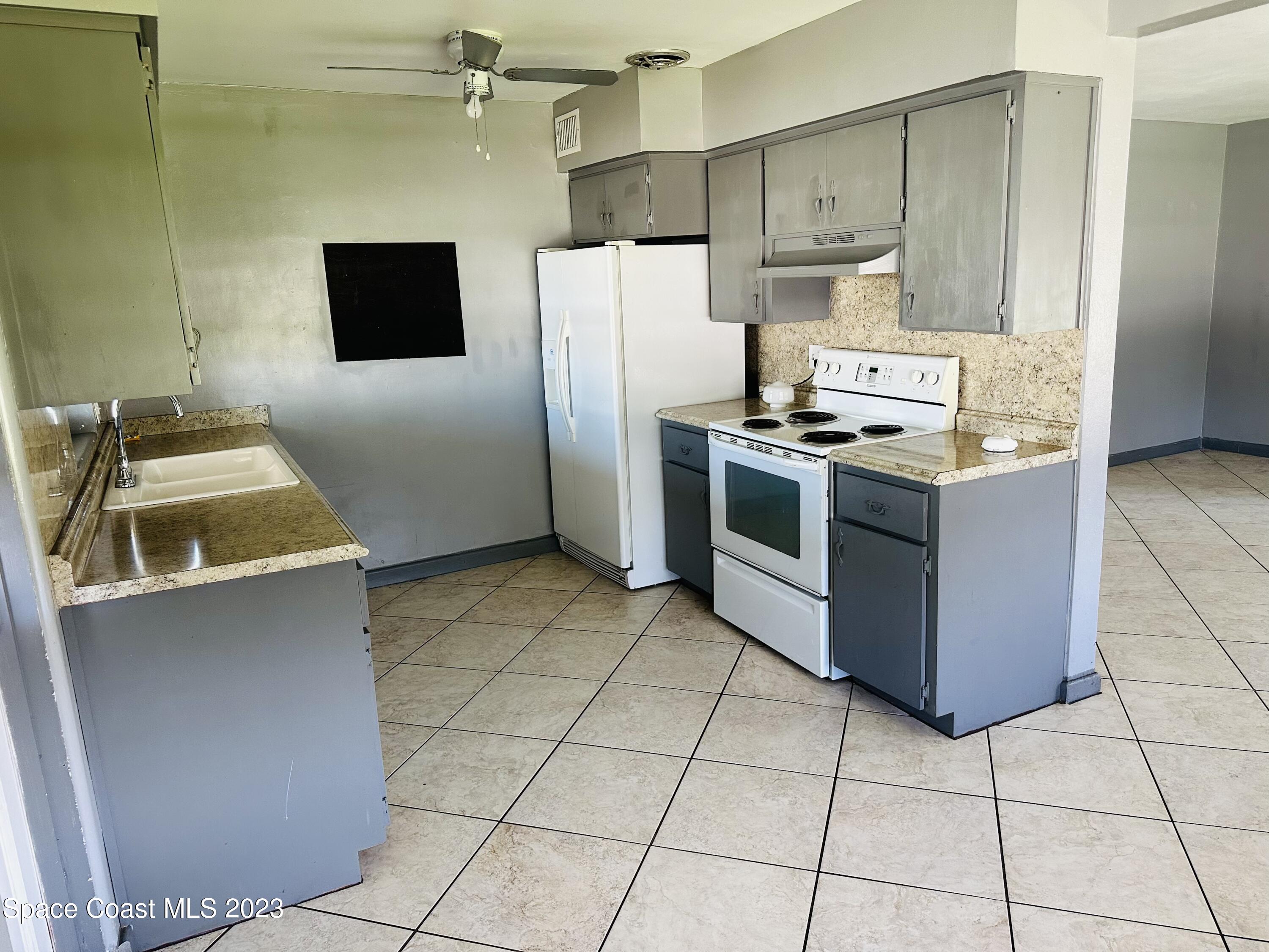 1972 Sarno Road Melbourne, FL 32935 - Photo 8 of 27 a kitchen with cabinets and steel stainless steel appliances