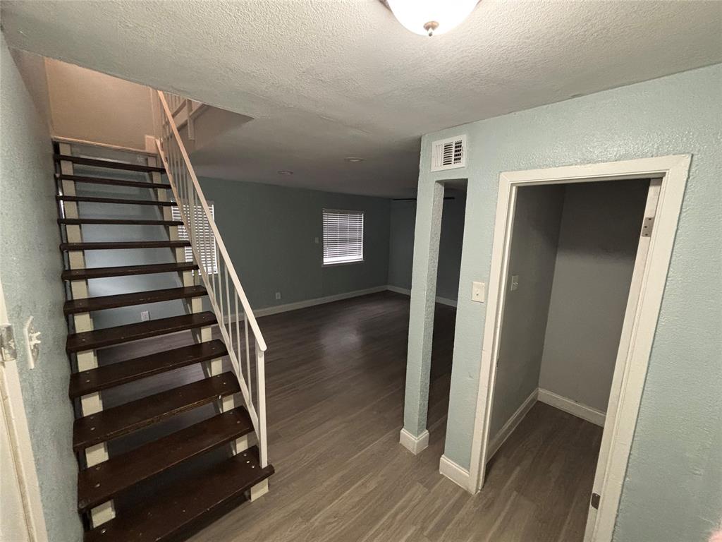 301 Rolston Road, Unit 315101 Irving, TX 75060 - Photo 12 of 12 Staircase featuring dark wood-finish treads and a white metal railing